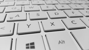 Close-up of white computer keyboard - Copy Trading