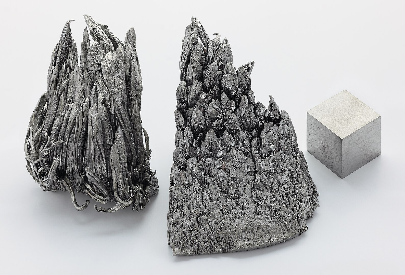 Yttrium, sublimed-dendritic, high purity 99.99 % Y/TREM. As well as an argon arc remelted 1 cm3 yttrium cube for comparison. Purity 99.9 %.